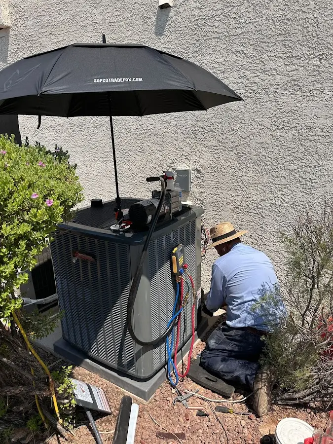 HVAC technician performing outdoor AC maintenance in Johnstown